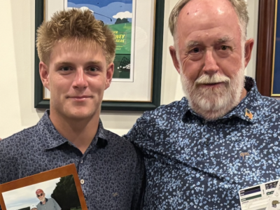 Logan and his grandfather pose with his thoughtful Christmas gift